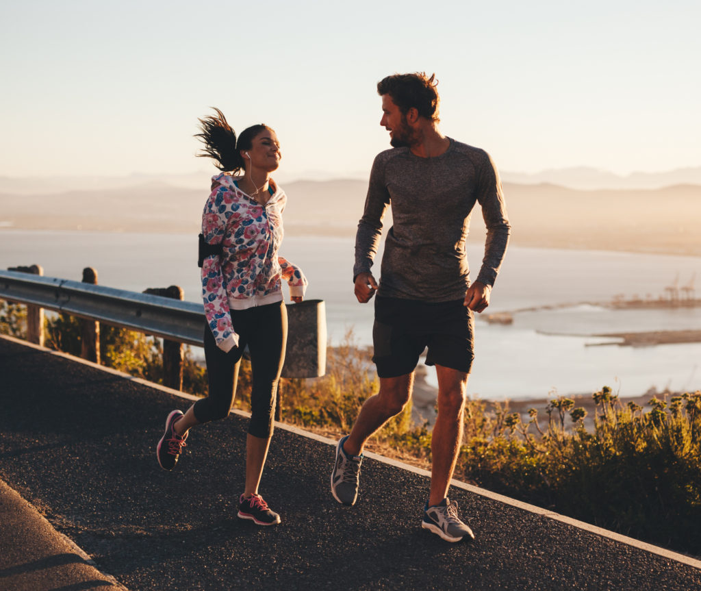 Man and woman running during the morning
